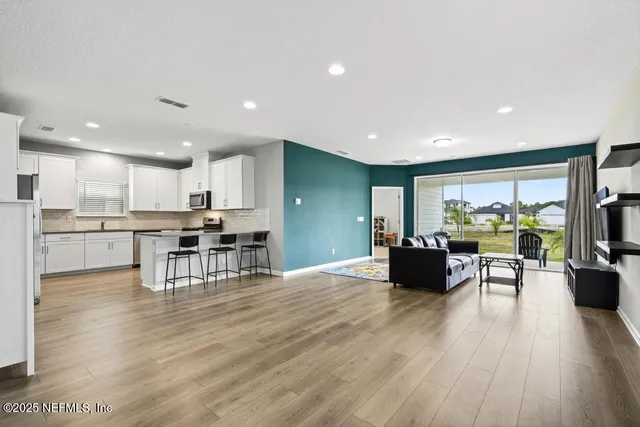 a view of kitchen with cabinets and wooden floor