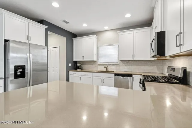 a kitchen with microwave and cabinets