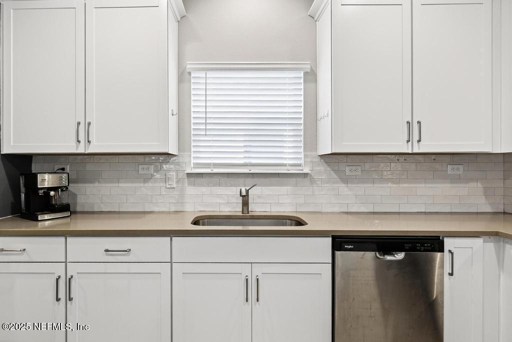 542 Silver Landing Drive St. Augustine, FL 32092 - Photo 19 of 55 a kitchen with stainless steel appliances granite countertop white cabinets sink and a granite counter top