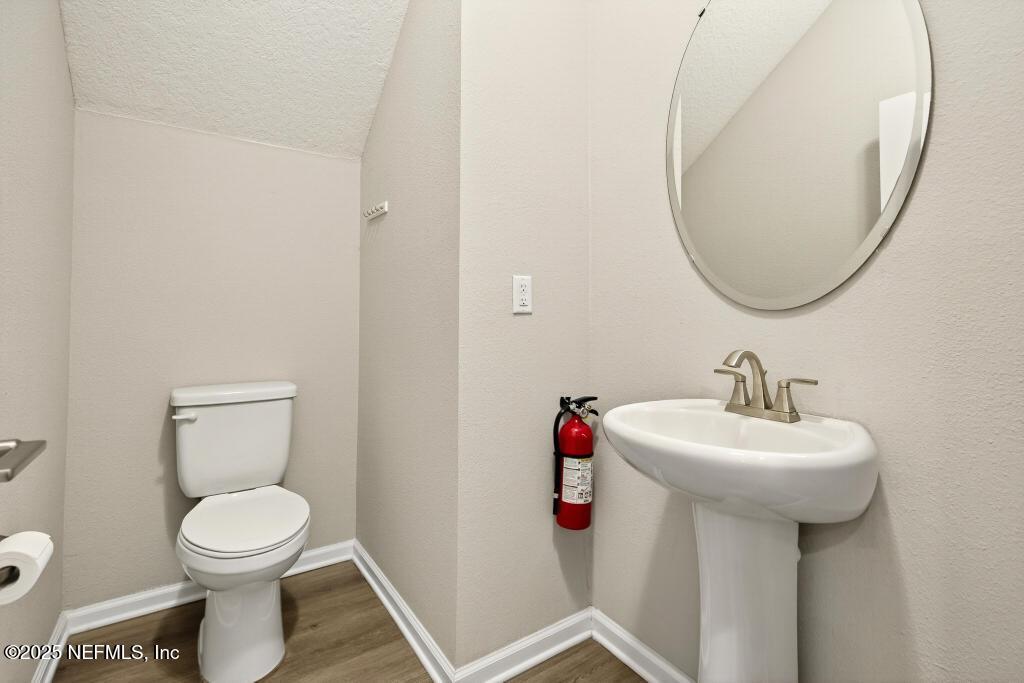542 Silver Landing Drive St. Augustine, FL 32092 - Photo 22 of 55 a bathroom with a toilet sink and mirror