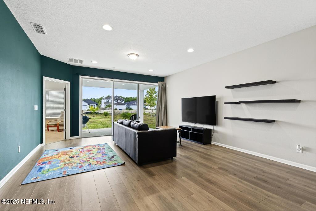 542 Silver Landing Drive St. Augustine, FL 32092 - Photo 24 of 55 a living room with furniture and a flat screen tv