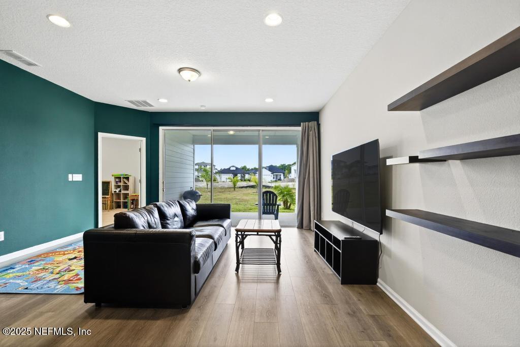 542 Silver Landing Drive St. Augustine, FL 32092 - Photo 25 of 55 a living room with furniture and a flat screen tv