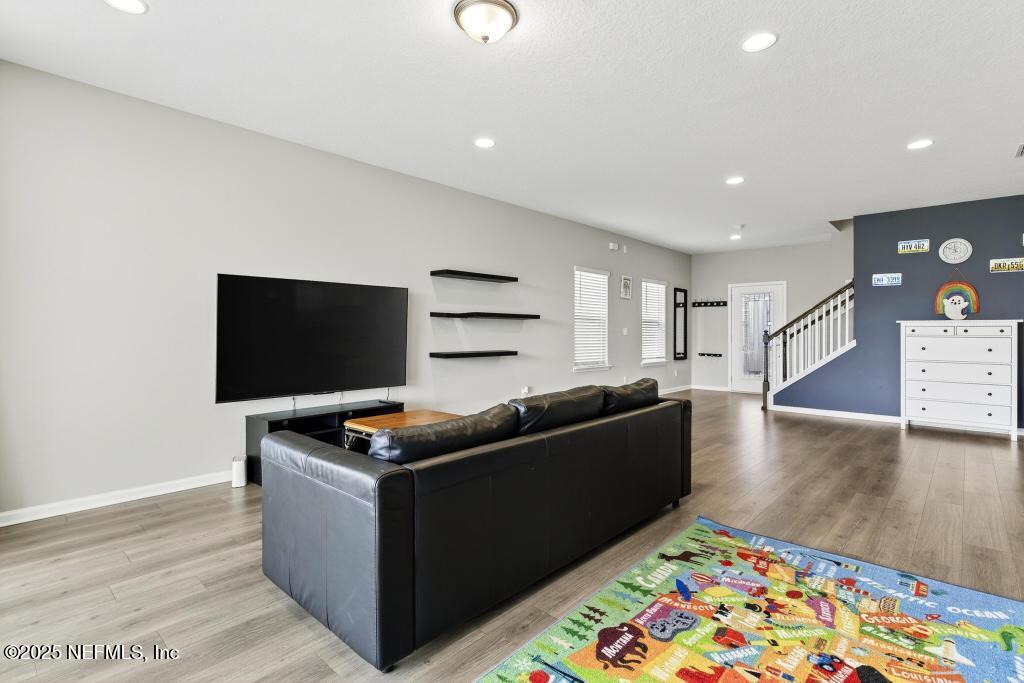 542 Silver Landing Drive St. Augustine, FL 32092 - Photo 26 of 55 a living room with furniture and a flat screen tv