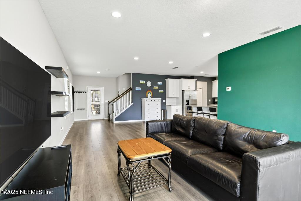 542 Silver Landing Drive St. Augustine, FL 32092 - Photo 27 of 55 a living room with furniture and a flat screen tv