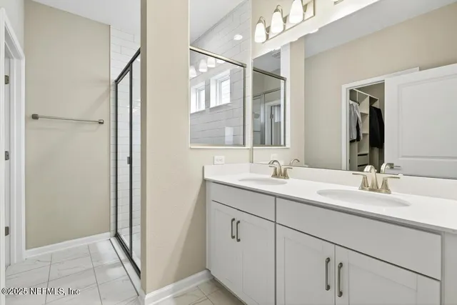 a bathroom with a glass door shower