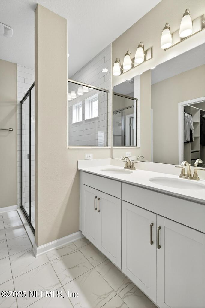 542 Silver Landing Drive St. Augustine, FL 32092 - Photo 31 of 55 a bathroom with a double vanity sink and mirror