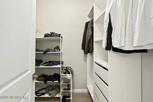 an empty room with windows and ceiling fan