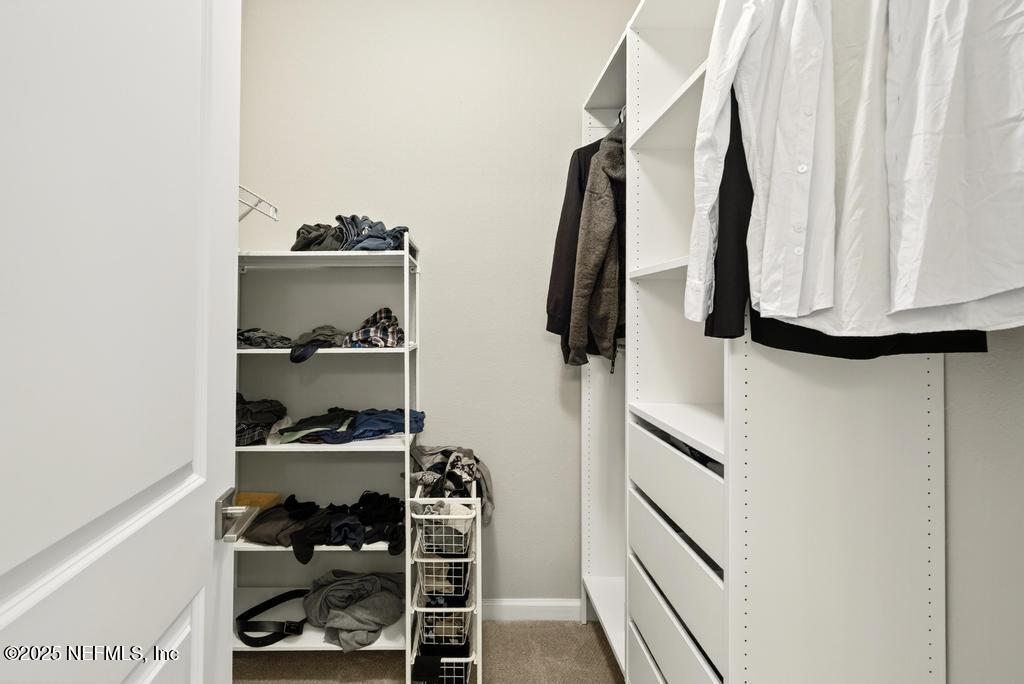 542 Silver Landing Drive St. Augustine, FL 32092 - Photo 34 of 55 a view of walk in closet with clothes and shoes