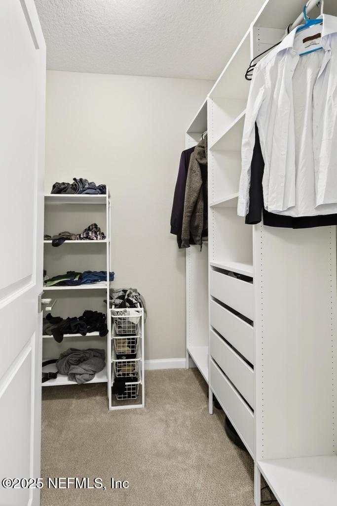 542 Silver Landing Drive St. Augustine, FL 32092 - Photo 35 of 55 a view of walk in closet with clothes and shoes