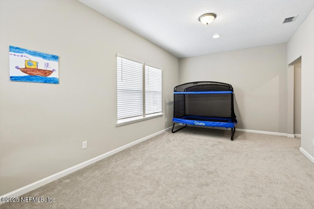 542 Silver Landing Drive St. Augustine, FL 32092 - Photo 38 of 55 an empty room with windows and ceiling fan