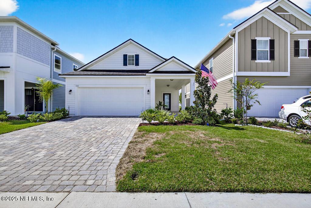 542 Silver Landing Drive St. Augustine, FL 32092 - Photo 4 of 55 a front view of a house with garden