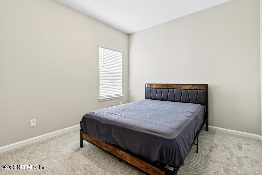 542 Silver Landing Drive St. Augustine, FL 32092 - Photo 41 of 55 a bedroom with a bed and window