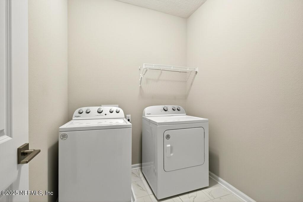 542 Silver Landing Drive St. Augustine, FL 32092 - Photo 47 of 55 a utility room with dryer and washer