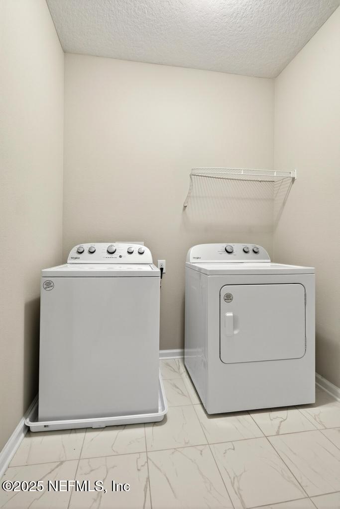 542 Silver Landing Drive St. Augustine, FL 32092 - Photo 48 of 55 a utility room with dryer and washer