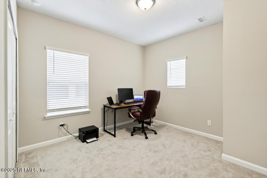 542 Silver Landing Drive St. Augustine, FL 32092 - Photo 49 of 55 a view of a workspace with a window