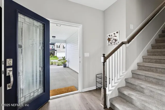 a view of an entryway with wooden floor