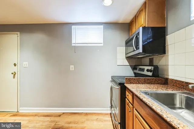 a kitchen with a sink and a refrigerator