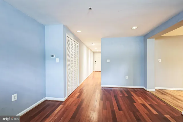 a view of a room with wooden floor and staircase