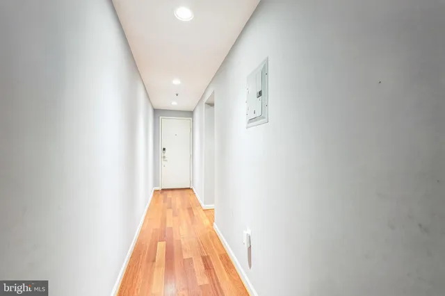 a view of a hallway with wooden floor