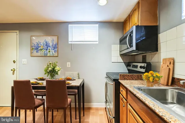 a kitchen with a sink cabinets and dining table