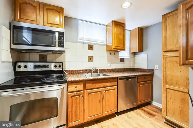 a kitchen with stainless steel appliances granite countertop a stove microwave and refrigerator