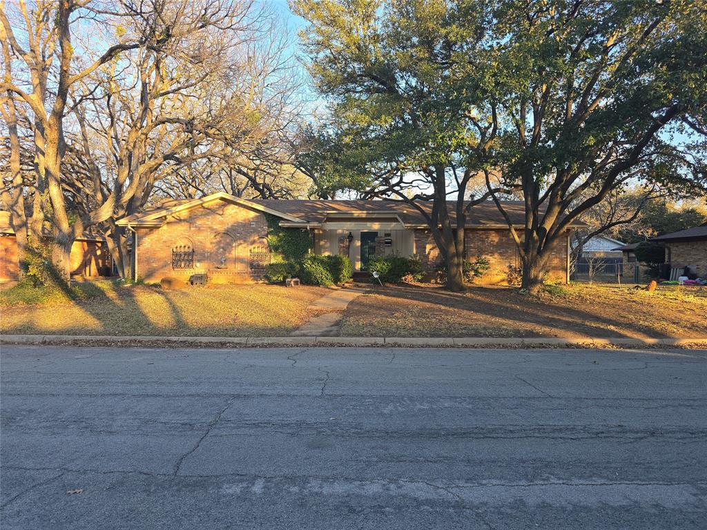 705 Lake Louise Road Fort Worth, TX 76103 - Photo 1 of 1 a view of road with trees