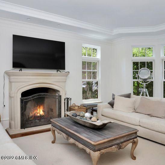 211 Orchard Street Cos Cob, CT 06830 - Photo 8 of 40 a living room with furniture a flat screen tv and a fireplace