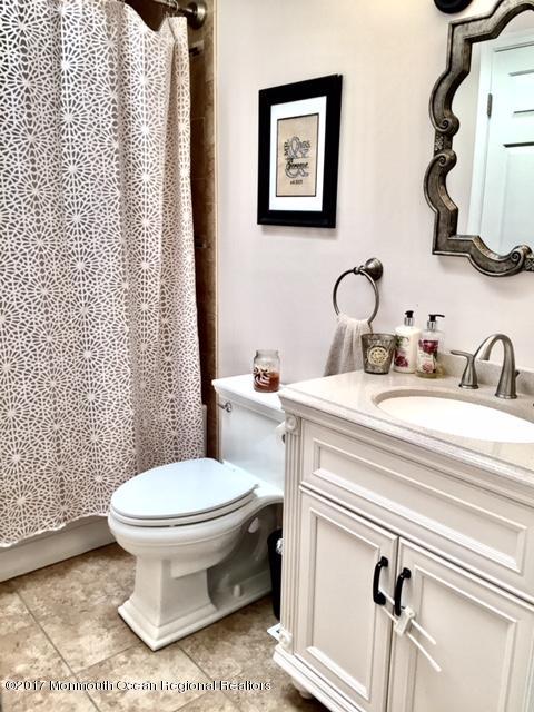 6 London Road Brick, NJ 08723 - Photo 8 of 12 a bathroom with a toilet sink and mirror
