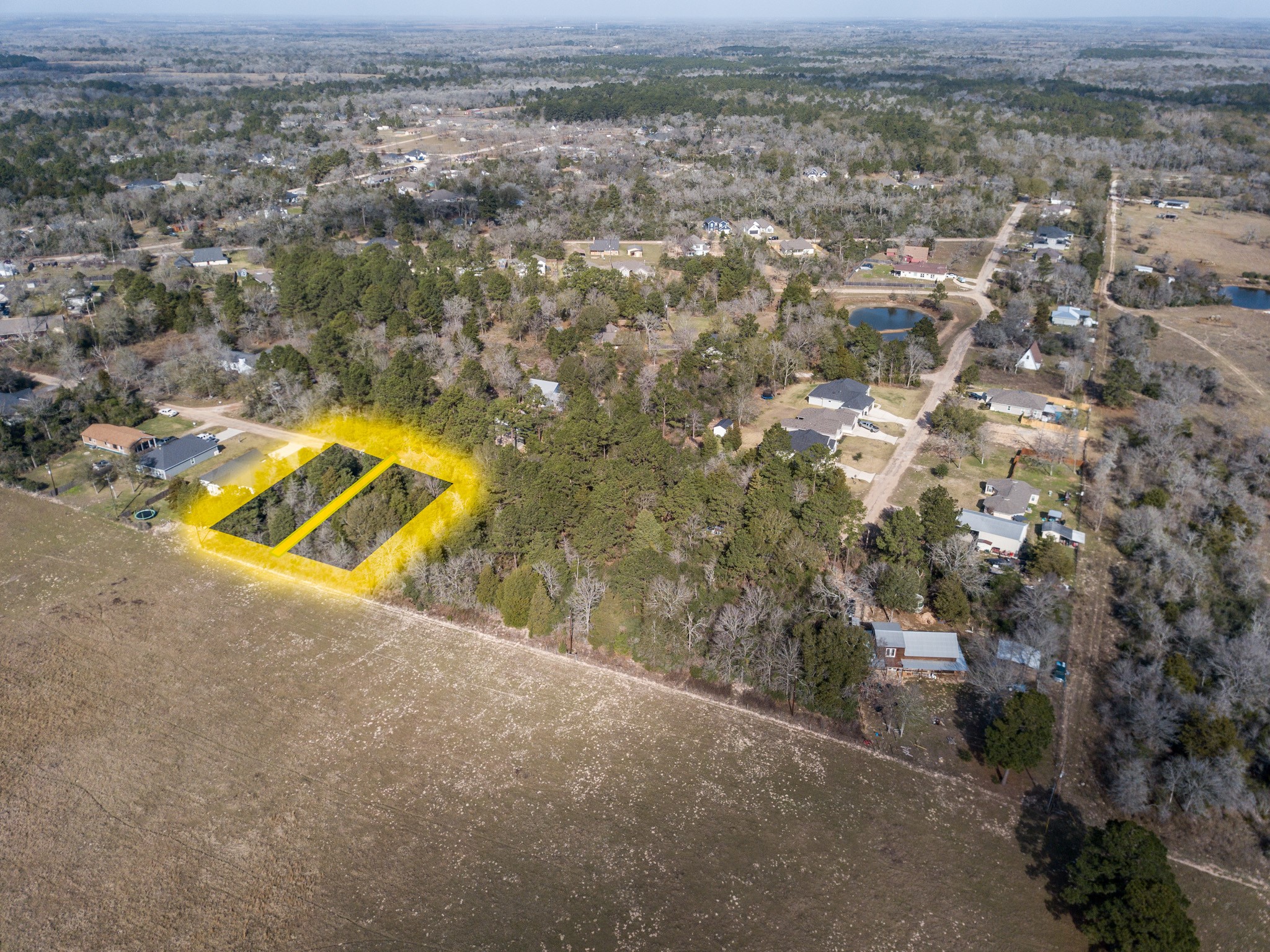 38044 Quail Drive Hempstead, TX 77445 - Photo 8 of 14 an aerial view of a house with a yard and lake view