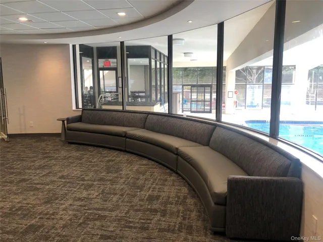 a living room with furniture and large windows