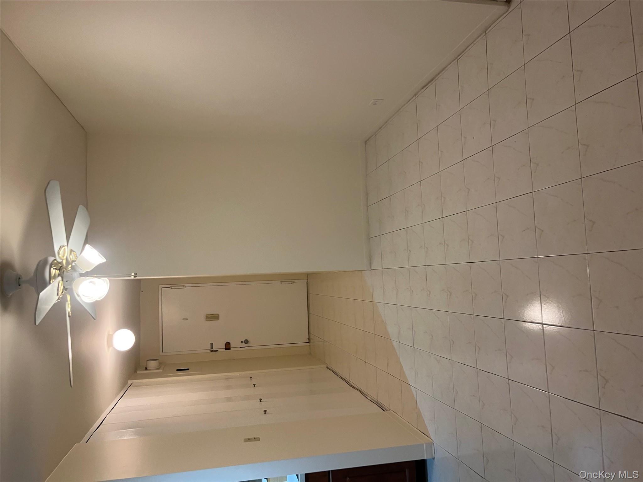 1 Bay Club Drive, Unit 6L Queens, NY 11360 - Photo 4 of 17 an empty room with fan and entrance