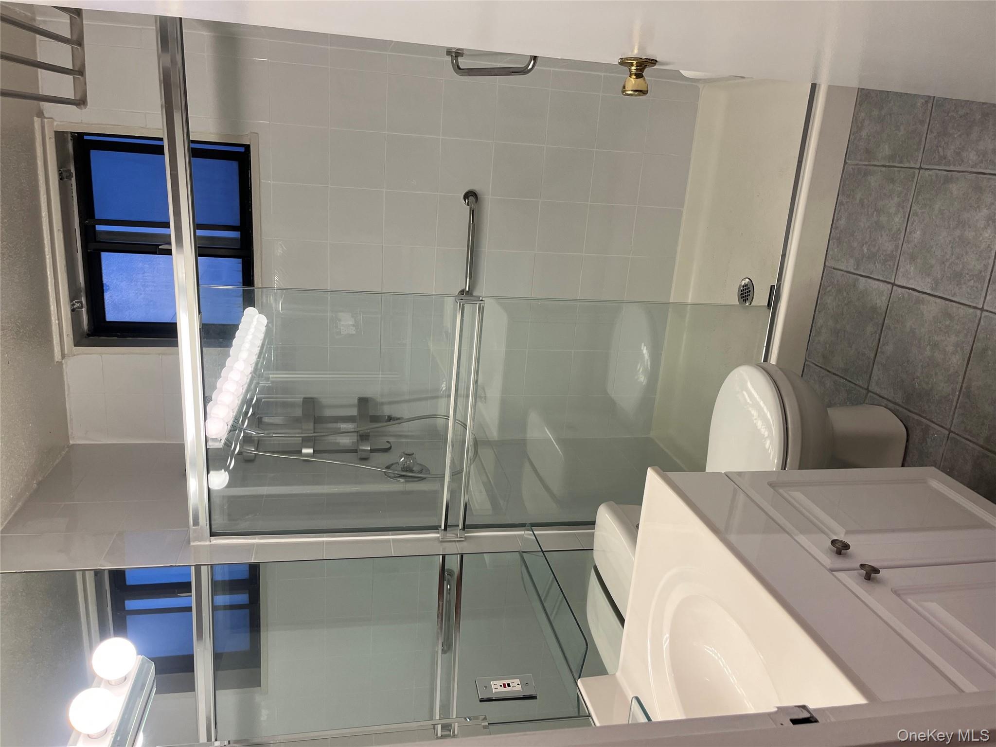 1 Bay Club Drive, Unit 6L Queens, NY 11360 - Photo 5 of 17 a bathroom with a sink a toilet and shower