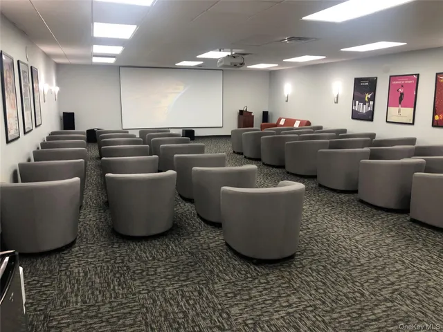 a room with lots of chairs and mirrors