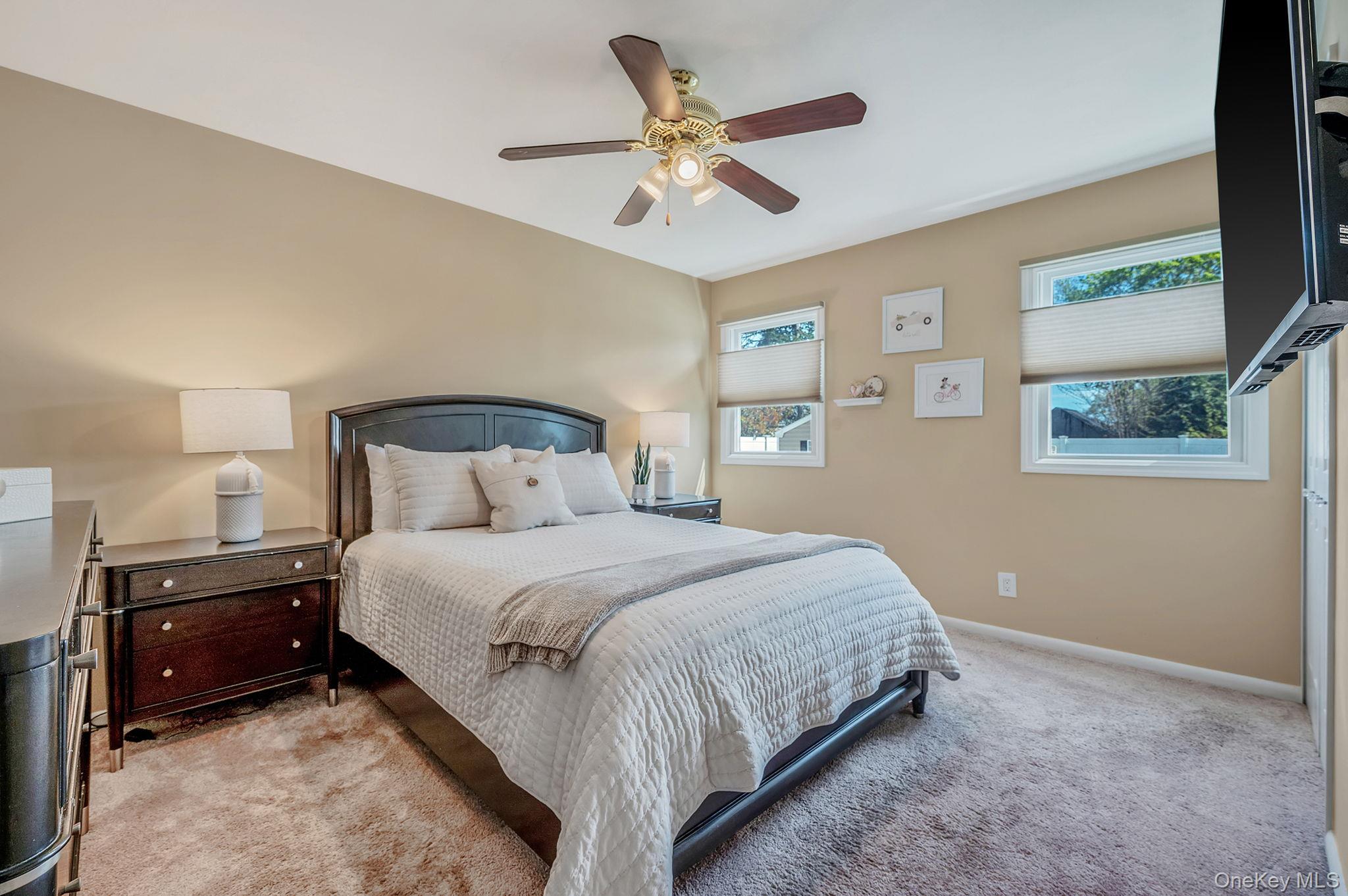 46 Sheldon Place Commack, NY 11725 - Photo 12 of 32 a bedroom with a bed and a ceiling fan
