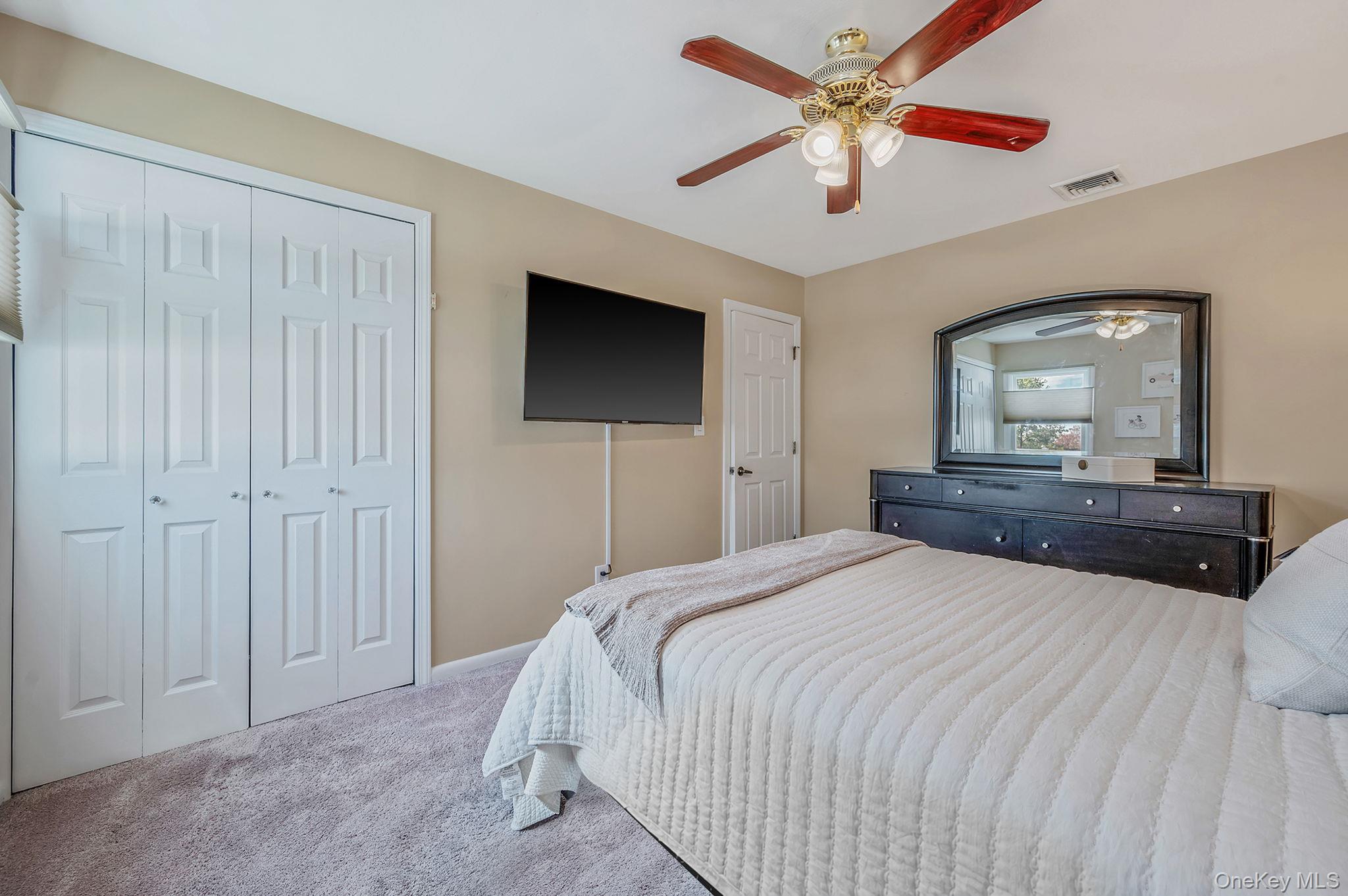 46 Sheldon Place Commack, NY 11725 - Photo 13 of 32 a bedroom with a bed and a flat screen tv