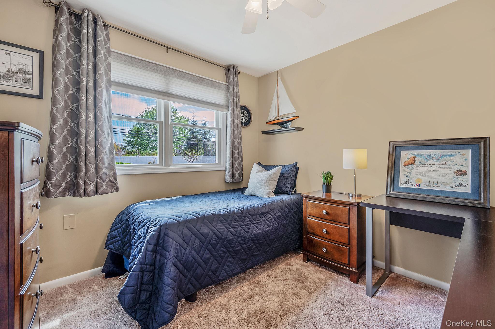 46 Sheldon Place Commack, NY 11725 - Photo 15 of 32 a bedroom with a bed painting on wall and a large window