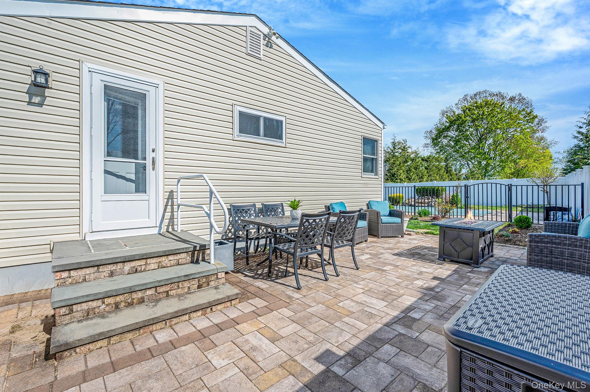 46 Sheldon Place Commack, NY 11725 - Photo 21 of 32 a view of a patio with a dining table and chairs with wooden floor and fence