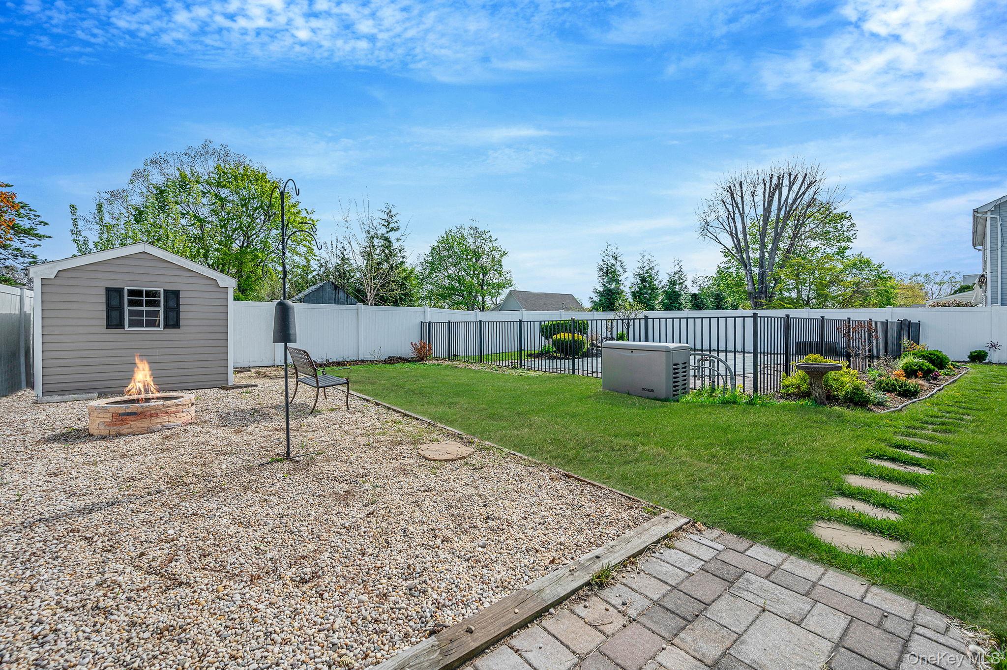 46 Sheldon Place Commack, NY 11725 - Photo 23 of 32 a front view of a house with a garden and trees