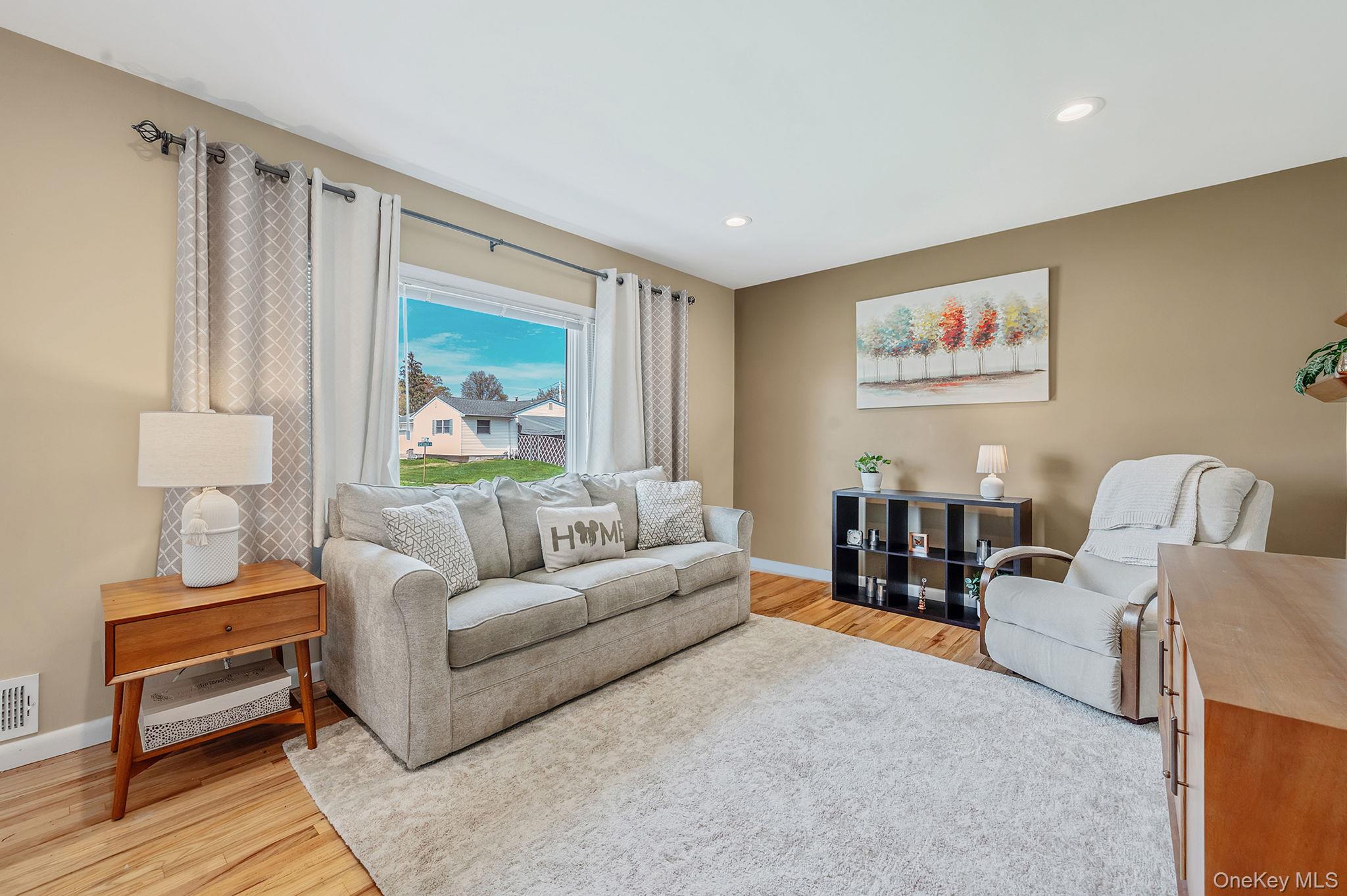 46 Sheldon Place Commack, NY 11725 - Photo 4 of 32 a living room with furniture and a painting on the wall