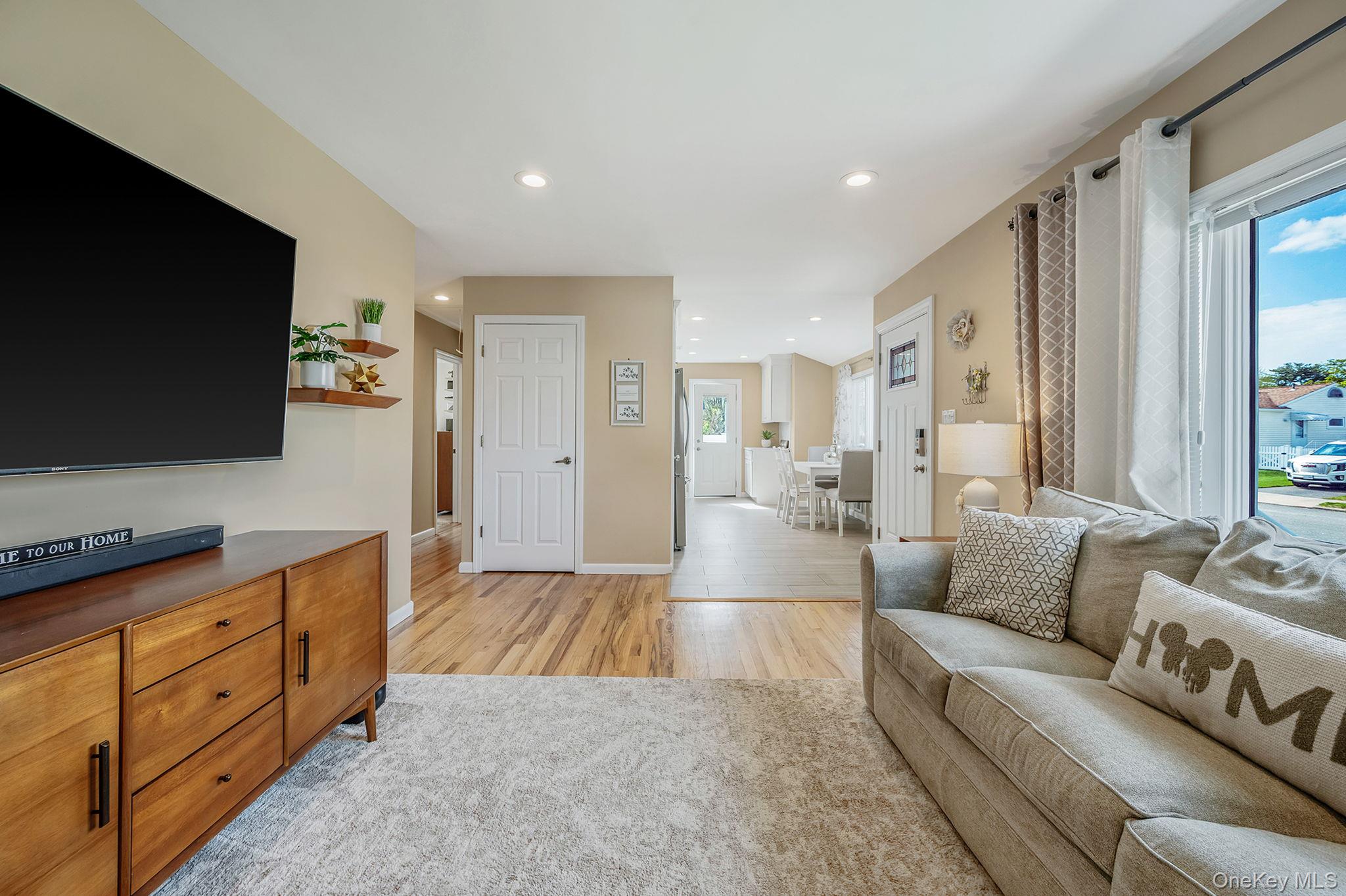 46 Sheldon Place Commack, NY 11725 - Photo 6 of 32 a living room with furniture and a flat screen tv