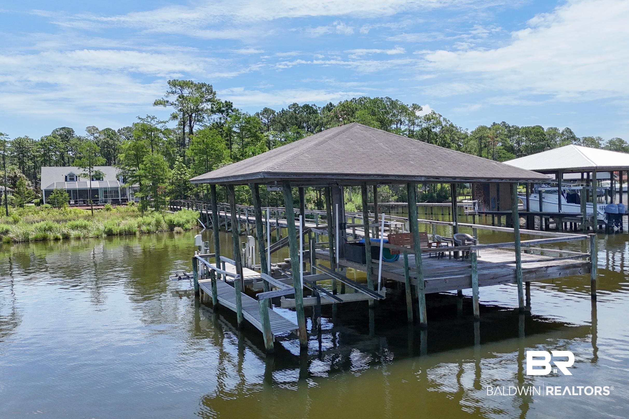 8585 Bay Harbor Road Elberta, AL 36530 - Photo 6 of 51 Dock area featuring boat lift, a water view, and view of scattered trees