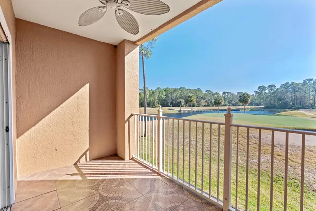 a view of a balcony with yard