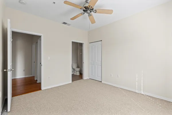 a view of a livingroom with a ceiling fan and window