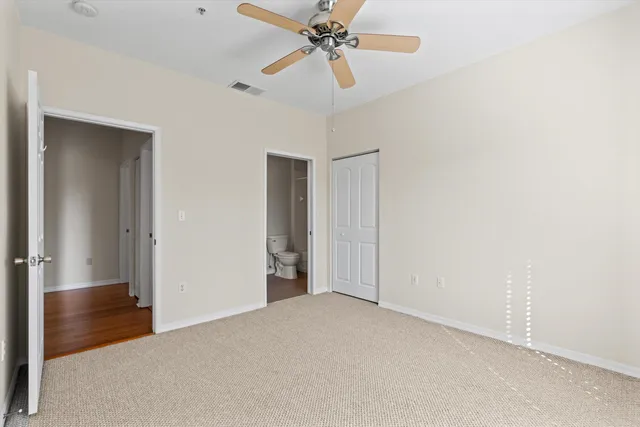a view of a livingroom with a ceiling fan and window