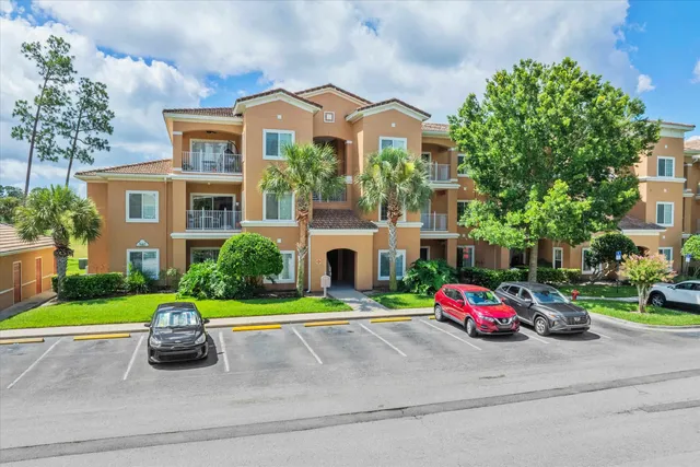 a front view of a house with a garden and parking