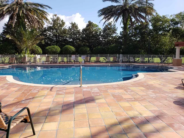 a view of swimming pool with seating space