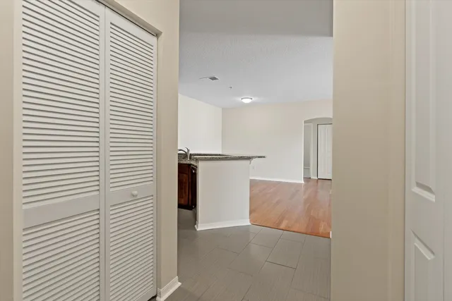 a view of a hallway with stainless steel appliances