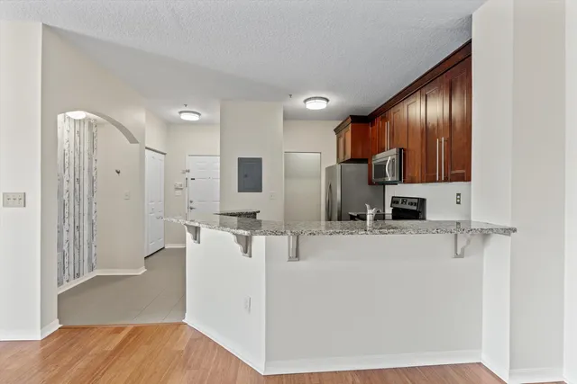 a kitchen with stainless steel appliances a refrigerator sink and cabinets
