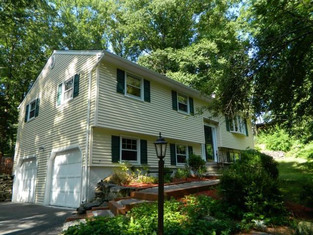 4 Baldwin Hill Road Brookfield, CT 06804 - Photo 1 of 1 a backyard of a house with table and chairs potted plants and large tree