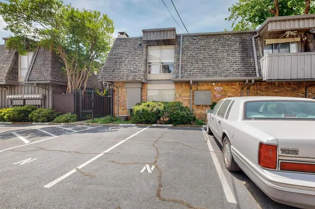 a cars parked in front of a brick house